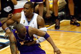ORLANDO, FL - JUNE 11:  Dwight Howard #12 of the Orlando Magic and Kobe Bryant #24 of the Los Angeles Lakers get tangeled up in the third quarter in Game Four of the 2009 NBA Finals on June 11, 2009 at Amway Arena in Orlando, Florida.  NOTE TO USER:  User expressly acknowledges and agrees that, by downloading and or using this photograph, User is consenting to the terms and conditions of the Getty Images License Agreement.  (Photo by Ronald Martinez/Getty Images)