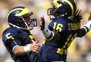 ANN ARBOR, MI - SEPTEMBER 05:  Tate Forcier #5 of the Michigan Wolverines celebrates with Denard Robinson #16 after Robinson ran for a long first quarter touchdown against the Western Michigan Broncos on September 5, 2009 at Michigan Stadium in Ann Arbor, Michigan.  (Photo by Gregory Shamus/Getty Images)