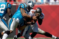 TAMPA, FL - OCTOBER 18:  Defensive end Julius Peppers #90 of the Carolina Panthers tackles quarterback Josh Johnson #11 of the Tampa Bay Buccaneers during the game at Raymond James Stadium on October 18, 2009 in Tampa, Florida.  (Photo by J. Meric/Getty Images)