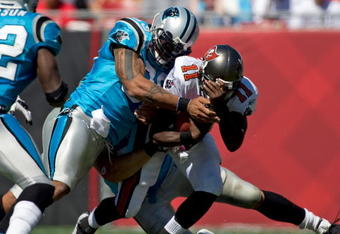 TAMPA, FL - OCTOBER 18:  Defensive end Julius Peppers #90 of the Carolina Panthers tackles quarterback Josh Johnson #11 of the Tampa Bay Buccaneers during the game at Raymond James Stadium on October 18, 2009 in Tampa, Florida.  (Photo by J. Meric/Getty Images)