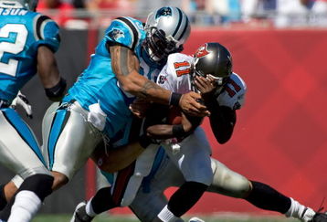 TAMPA, FL - OCTOBER 18:  Defensive end Julius Peppers #90 of the Carolina Panthers tackles quarterback Josh Johnson #11 of the Tampa Bay Buccaneers during the game at Raymond James Stadium on October 18, 2009 in Tampa, Florida.  (Photo by J. Meric/Getty Images)
