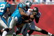 TAMPA, FL - OCTOBER 18:  Defensive end Julius Peppers #90 of the Carolina Panthers tackles quarterback Josh Johnson #11 of the Tampa Bay Buccaneers during the game at Raymond James Stadium on October 18, 2009 in Tampa, Florida.  (Photo by J. Meric/Getty Images)