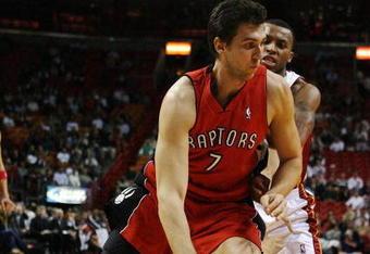 MIAMI - NOVEMBER 19:  Andrea Bargnani #7 of the Toronto Raptors drives past Daequan Cook #14 of the Miami Heat at American Airlines Arena on November 19, 2008 in Miami, Florida. The Raptors defeated the Heat 101-95. NOTE TO USER: User expressly acknowledges and agrees that, by downloading and/or using this Photograph, user is consenting to the terms and conditions of the Getty Images License Agreement.  (Photo by Doug Benc/Getty Images)