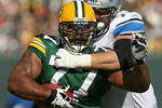 GREEN BAY, WI - OCTOBER 18: Cullen Jenkins #77 of the Green Bay Packers tries to run after intercepting a pass as Jeff Backus #76 of Detroit Lions drags him down at Lambeau Field on October 18, 2009 in Green Bay, Wisconsin. (Photo by Jonathan Daniel/Getty Images)