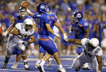 BOISE, ID - SEPTEMBER 3: Quarterback Kellen Moore #11 of the Boise State Broncos gets off a pass under the rush of Zac Clark #99 and Terrance Montgomery #59 of the Oregon Ducks in the fourth quarter of the game on September 3, 2009 at Bronco Stadium in Boise, Idaho. Boise State won the game 19-8. (Photo by Steve Dykes/Getty Images)