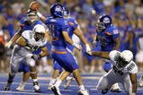 BOISE, ID - SEPTEMBER 3: Quarterback Kellen Moore #11 of the Boise State Broncos gets off a pass under the rush of Zac Clark #99 and Terrance Montgomery #59 of the Oregon Ducks in the fourth quarter of the game on September 3, 2009 at Bronco Stadium in Boise, Idaho. Boise State won the game 19-8. (Photo by Steve Dykes/Getty Images)