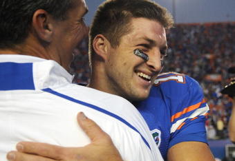 GAINESVILLE, FL - OCTOBER 17: Quarterback Tim Tebow #15 of the Florida Gators celebrates a win with coach Urban Meyer against the University of Arkansas Razorbacks October 17, 2009 at Ben Hill Griffin Stadium in Gainesville, Florida.  (Photo by Al Messerschmidt/Getty Images)