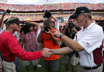 LANDOVER, MD - SEPTEMBER 12:  Head coach Joe Gibbs of the Washington Redskins (R) is congratulated by head coach Jon Gruden of the Tampa Bay Buccaneers at mid-field after the Redskins defeated the Buccaneers 16-10 on September 12, 2004 at FedEx Field in Landover, Maryland.  (Photo by Doug Pensinger/Getty Images)