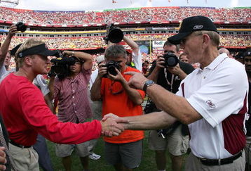 LANDOVER, MD - SEPTEMBER 12:  Head coach Joe Gibbs of the Washington Redskins (R) is congratulated by head coach Jon Gruden of the Tampa Bay Buccaneers at mid-field after the Redskins defeated the Buccaneers 16-10 on September 12, 2004 at FedEx Field in Landover, Maryland.  (Photo by Doug Pensinger/Getty Images)