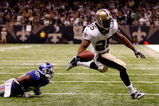 NEW ORLEANS - OCTOBER 18:  Reggie Bush #25 of the New Orleans Saints scores a touchdown over Kevin Dockery #35 of the New York Giants at the Louisiana Superdome on October 18, 2009 in New Orleans, Louisiana.  (Photo by Chris Graythen/Getty Images)