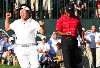 CHASKA, MN - AUGUST 16:  (L-R) Y.E. Yang of South Korea celebrates a birdie putt on the 18th green alongside Tiger Woods during the final round of the 91st PGA Championship at Hazeltine National Golf Club on August 16, 2009 in Chaska, Minnesota.  (Photo by David Cannon/Getty Images)