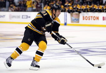 BOSTON - OCTOBER 10:  Marc Savard #91 of the Boston Bruins takes the puck to the net against the New York Islanders to score the game winner in the overtime shootout on October 10, 2009 at the TD Garden in Boston, Massachusetts. The Bruins defeated the Islanders 4-3 in an overtime shootout.  (Photo by Elsa/Getty Images)