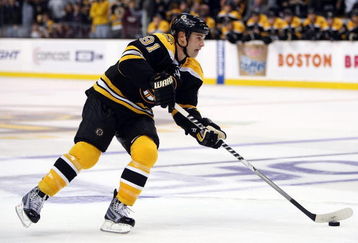 BOSTON - OCTOBER 10:  Marc Savard #91 of the Boston Bruins takes the puck to the net against the New York Islanders to score the game winner in the overtime shootout on October 10, 2009 at the TD Garden in Boston, Massachusetts. The Bruins defeated the Islanders 4-3 in an overtime shootout.  (Photo by Elsa/Getty Images)