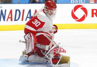 TORONTO, ON - SEPTEMBER 26:  Chris Osgood #30 of the Detroit Red Wings kicks aside a shot in a pre-season game against the Toronto Maple Leafs on September 26, 2009 at the Air Canada Centre in Toronto, Ontario. The Leafs defeated the Red Wings 2-1. (Photo by Claus Andersen/Getty Images)