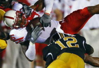 COLUMBIA, MO - OCTOBER 6:  Maurice Purify #16 of the Nebraska Cornhuskers is upended by Sean Weatherspoon #12 and Justin Garrett #8 of the Missouri Tigers during 2nd-half action on October 6, 2007 at Faurot Field in Columbia, Missouri.  Missouri won 41-6. (Photo by G. Newman Lowrance/Getty Images)