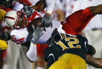 COLUMBIA, MO - OCTOBER 6:  Maurice Purify #16 of the Nebraska Cornhuskers is upended by Sean Weatherspoon #12 and Justin Garrett #8 of the Missouri Tigers during 2nd-half action on October 6, 2007 at Faurot Field in Columbia, Missouri.  Missouri won 41-6. (Photo by G. Newman Lowrance/Getty Images)
