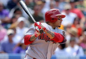 DENVER - JULY 05:  Felipe Lopez #2 of the Arizona Diamondbacks follows through on his game winning RBI single to centerfield off of starting pitcher Ubaldo Jimenez of the Colorado Rockies to score Gerardo Parra in the seventh inning during MLB action at Coors Field on July 5, 2009 in Denver, Colorado. The Diamondbacks defeated the Rockies 4-3.  (Photo by Doug Pensinger/Getty Images)
