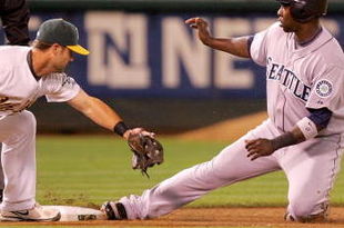 OAKLAND, CA - SEPTEMBER 04:  Bill Hall #3 of the Seattle Mariners slides safely under the tag of Adam Kennedy #29 of the Oakland Athletics in the eighth inning at the Oakland Coliseum on September 4, 2009 in Oakland, California. Hall advanced on a hit by Kenji Johjima and later scored in the inning to give the Mariners a 5-3 lead.  (Photo by Ezra Shaw/Getty Images)