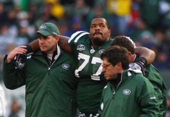 EAST RUTHERFORD, NJ - OCTOBER 18:  Kris Jenkins #77 of the New York Jets is helped off the field after being injured in the second quarter against the Buffalo Bills at Giants Stadium in the Meadowlands on October 18, 2009 in East Rutherford, New Jersey.  (Photo by Mike Stobe/Getty Images)
