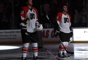 SUNRISE, FL - OCTOBER 16: Chris Pronger #20 and Mike Richards #18 of the Philadelphia Flyers stand during the playing of the national anthem prior to the game against the Florida Panthers on October 16, 2009 at the BankAtlantic Center in Sunrise, Florida. (Photo by Joel Auerbach/Getty Images)