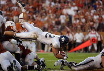 AUSTIN, TX - SEPTEMBER 20:  James Casey #12 of the Rice Owls dives during the game against the Texas Longhorns on September 20, 2008 at Darrell K Royal-Texas Memorial Stadium in Austin, Texas. Texas won 52-10. (Photo by Brian Bahr/Getty Images)