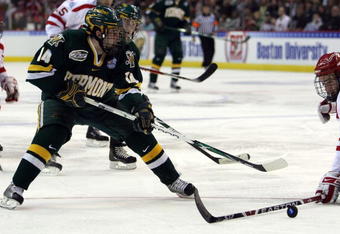 WASHINGTON - APRIL 09:  Brian Roloff #14 of the Vermont Catamounts tries to get around Eric Gryba #2 of the Boston Terriers during the NCAA Men's Frozen Four Semifinal game on April 9, 2009 at the Verizon Center in Washington, DC.  (Photo by Elsa/Getty Images)