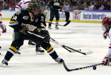 WASHINGTON - APRIL 09:  Brian Roloff #14 of the Vermont Catamounts tries to get around Eric Gryba #2 of the Boston Terriers during the NCAA Men's Frozen Four Semifinal game on April 9, 2009 at the Verizon Center in Washington, DC.  (Photo by Elsa/Getty Images)