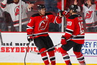 NEWARK, NJ - OCTOBER 17:  Zach Parise #9 of the New Jersey Devils celebrates his empty net goal late in the third period with teammate Travis Zajac #19 to give the Devils a 2 to 0 win over the Carolina Hurricanes at the Prudential Center on October 17, 2009 in Newark, New Jersey.  (Photo by Paul Bereswill/Getty Images)