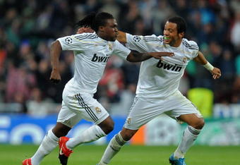 MADRID, SPAIN - OCTOBER 21:  Royston Drenthe (L) of Real Madrid celebrates scoring his side equalizing goal with his teammate Marcelo Vieira during the Champions League group C match between Real Madrid and AC Milan at the Estadio Santiago Bernabeu on October 21, 2009 in Madrid, Spain.  (Photo by Jasper Juinen/Getty Images)