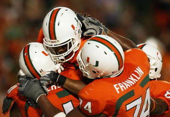 FORT LAUDERDALE, FL - OCTOBER 03: Wide receiver Travis Benjamin #3 of the Miami Hurricanes celebrates his touchdown with teammates Joel Figueroa #61 and Orlando Franklin #74 against the Oklahoma Sooners at Land Shark Stadium on October 3, 2009 in Fort Lauderdale, Florida. Miami defeated Oklahoma 21-20. (Photo by Doug Benc/Getty Images)