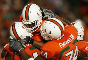 FORT LAUDERDALE, FL - OCTOBER 03: Wide receiver Travis Benjamin #3 of the Miami Hurricanes celebrates his touchdown with teammates Joel Figueroa #61 and Orlando Franklin #74 against the Oklahoma Sooners at Land Shark Stadium on October 3, 2009 in Fort Lauderdale, Florida. Miami defeated Oklahoma 21-20. (Photo by Doug Benc/Getty Images)