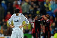 MADRID, SPAIN - OCTOBER 21:  Kaka (L) of Real Madrid stands dejected after conceding a goal as AC Milan players celebrate in the background during the Champions League group C match between Real Madrid and AC Milan at the Estadio Santiago Bernabeu on October 21, 2009 in Madrid, Spain. AC Milan won the match 3-2.  (Photo by Jasper Juinen/Getty Images)