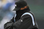 CHICAGO - APRIL 13: First base umpire Tim McClelland #36 tries to stay warm in between innings of the Opening Day game between the Chicago Cubs and the Colorado Rockies on April 13, 2009 at Wrigley Field in Chicago, Illinois. (Photo by Jonathan Daniel/Getty Images)