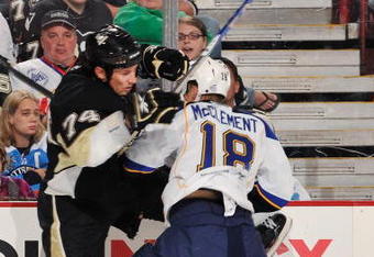 PITTSBURGH - OCTOBER 20: Jay McClement #18 of the St. Louis Blues checks Jay McKee #74 of the Pittsburgh Penguins on October 20, 2009 at Mellon Arena in Pittsburgh, Pennsylvania.  (Photo by Jamie Sabau/Getty Images)