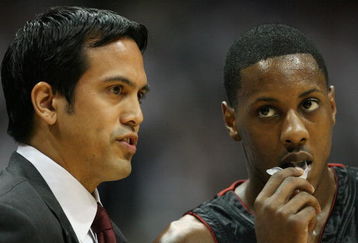 ATLANTA - APRIL 29:  Head coach Erik Spoelstra talks with Mario Chalmers #6 of the Miami Heat while taking on the Atlanta Hawks during Game Five of the Eastern Conference Quarterfinals at Philips Arena on April 29, 2009 in Atlanta, Georgia. NOTE TO USER: User expressly acknowledges and agrees that, by downloading and/or using this Photograph, user is consenting to the terms and conditions of the Getty Images License Agreement.  (Photo by Doug Benc/Getty Images)