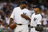 NEW YORK - AUGUST 08:  CC Sabathia #52 of the New York Yankees is congratulated by team mate Derek Jeter #2 before being taken out of the game in the eighth inning against the Boston Red Sox during their game on August 8, 2009 at Yankee Stadium in the Bronx borough of New York City.  (Photo by Chris McGrath/Getty Images)