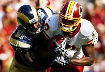 LANDOVER, MD - SEPTEMBER 20:  Malcom Kelly #12 of the Washington Redskins is tackled by Will Witherspoon #51 of the St. Louis Rams during their game on September 20, 2009 at FedEx Field in Landover, Maryland.  The Redskins defeated the Rams by a score of 9-7.  (Photo by Win McNamee/Getty Images)