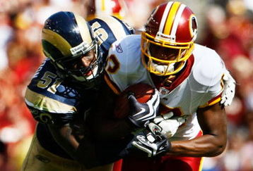 LANDOVER, MD - SEPTEMBER 20:  Malcom Kelly #12 of the Washington Redskins is tackled by Will Witherspoon #51 of the St. Louis Rams during their game on September 20, 2009 at FedEx Field in Landover, Maryland.  The Redskins defeated the Rams by a score of 9-7.  (Photo by Win McNamee/Getty Images)