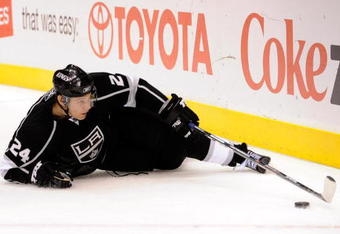 LOS ANGELES, CA - OCTOBER 06: Alexander Frolov #24 of the Los Angeles Kings reaches for the puck against San Jose Sharks during the NHL hockey game on October 6, 2009 in Los Angeles, California.  (Photo by Kevork Djansezian/Getty Images)