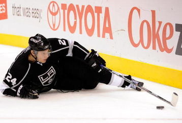 LOS ANGELES, CA - OCTOBER 06: Alexander Frolov #24 of the Los Angeles Kings reaches for the puck against San Jose Sharks during the NHL hockey game on October 6, 2009 in Los Angeles, California.  (Photo by Kevork Djansezian/Getty Images)
