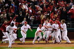 PHILADELPHIA - OCTOBER 19:  The Philadelphia Phillies celebrate after Carlos Ruiz scored the winning run on a walkoff 2-run double by Jimmy Rollins #11 in the bottom of the ninth inning to win 5-4 against the Los Angeles Dodgers in Game Four of the NLCS during the 2009 MLB Playoffs at Citizens Bank Park on October 19, 2009 in Philadelphia, Pennsylvania.  (Photo by Jeff Zelevansky/Getty Images)