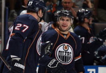 EDMONTON, CANADA - SEPTEMBER 23:  Gilbert Brule #67 of the Edmonton Oilers celebrates with Dustin Penner #27 during the game against the Calgary Flames on September 23, 2009 at Rexall Place in Edmonton, Alberta, Canada. (Photo by Dale MacMillan/Getty Images)
