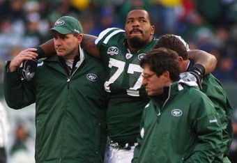 EAST RUTHERFORD, NJ - OCTOBER 18:  Kris Jenkins #77 of the New York Jets is helped off the field after being injured in the second quarter against the Buffalo Bills at Giants Stadium in the Meadowlands on October 18, 2009 in East Rutherford, New Jersey.  (Photo by Mike Stobe/Getty Images)