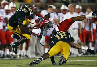 COLUMBIA, MO - OCTOBER 6:  Maurice Purify #16 of the Nebraska Cornhuskers is upended by Sean Weatherspoon #12 and Justin Garrett #8 of the Missouri Tigers during 2nd-half action on October 6, 2007 at Faurot Field in Columbia, Missouri.  Missouri won 41-6. (Photo by G. Newman Lowrance/Getty Images)