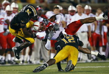 COLUMBIA, MO - OCTOBER 6:  Maurice Purify #16 of the Nebraska Cornhuskers is upended by Sean Weatherspoon #12 and Justin Garrett #8 of the Missouri Tigers during 2nd-half action on October 6, 2007 at Faurot Field in Columbia, Missouri.  Missouri won 41-6. (Photo by G. Newman Lowrance/Getty Images)