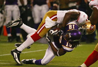 MINNEAPOLIS - SEPTEMBER 27: Takeo Spikes #51 of the San Francisco 49ers tackles Sidney Rice #18 of the Minnesota Vikings at the Hubert H. Humphrey Metrodome on September 27, 2009 in Minneapolis, Minnesota. The Vikings defeated the 49ers 27-24.  (Photo by Jonathan Daniel/Getty Images)