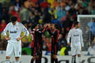 MADRID, SPAIN - OCTOBER 21: Kaka (L) of Real Madrid stands dejected after conceding a goal as AC Milan players celebrate in the background during the Champions League group C match between Real Madrid and AC Milan at the Estadio Santiago Bernabeu on October 21, 2009 in Madrid, Spain. AC Milan won the match 3-2. (Photo by Jasper Juinen/Getty Images)