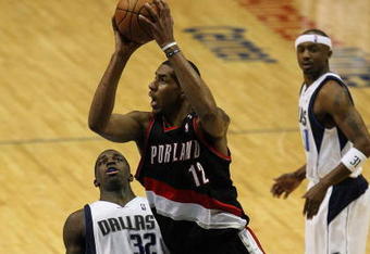 DALLAS - FEBRUARY 04:  LaMarcus Aldridge #12 of the Portland Trail Blazers takes a shot against Brandon Bass #32 of the Dallas Mavericks on February 4, 2009 at American Airlines Center in Dallas, Texas.  NOTE TO USER: User expressly acknowledges and agrees that, by downloading and/or using this Photograph, user is consenting to the terms and conditions of the Getty Images License Agreement.  (Photo by Ronald Martinez/Getty Images)
