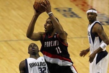 DALLAS - FEBRUARY 04:  LaMarcus Aldridge #12 of the Portland Trail Blazers takes a shot against Brandon Bass #32 of the Dallas Mavericks on February 4, 2009 at American Airlines Center in Dallas, Texas.  NOTE TO USER: User expressly acknowledges and agrees that, by downloading and/or using this Photograph, user is consenting to the terms and conditions of the Getty Images License Agreement.  (Photo by Ronald Martinez/Getty Images)