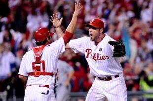 PHILADELPHIA - OCTOBER 21:  Brad Lidge #54 and Carlos Ruiz #51 of the Philadelphia Phillies celebrate defeating the Los Angeles Dodgers 10-4 to advance to the World Series in Game Five of the NLCS during the 2009 MLB Playoffs at Citizens Bank Park on October 21, 2009 in Philadelphia, Pennsylvania.  (Photo by Jeff Zelevansky/Getty Images)